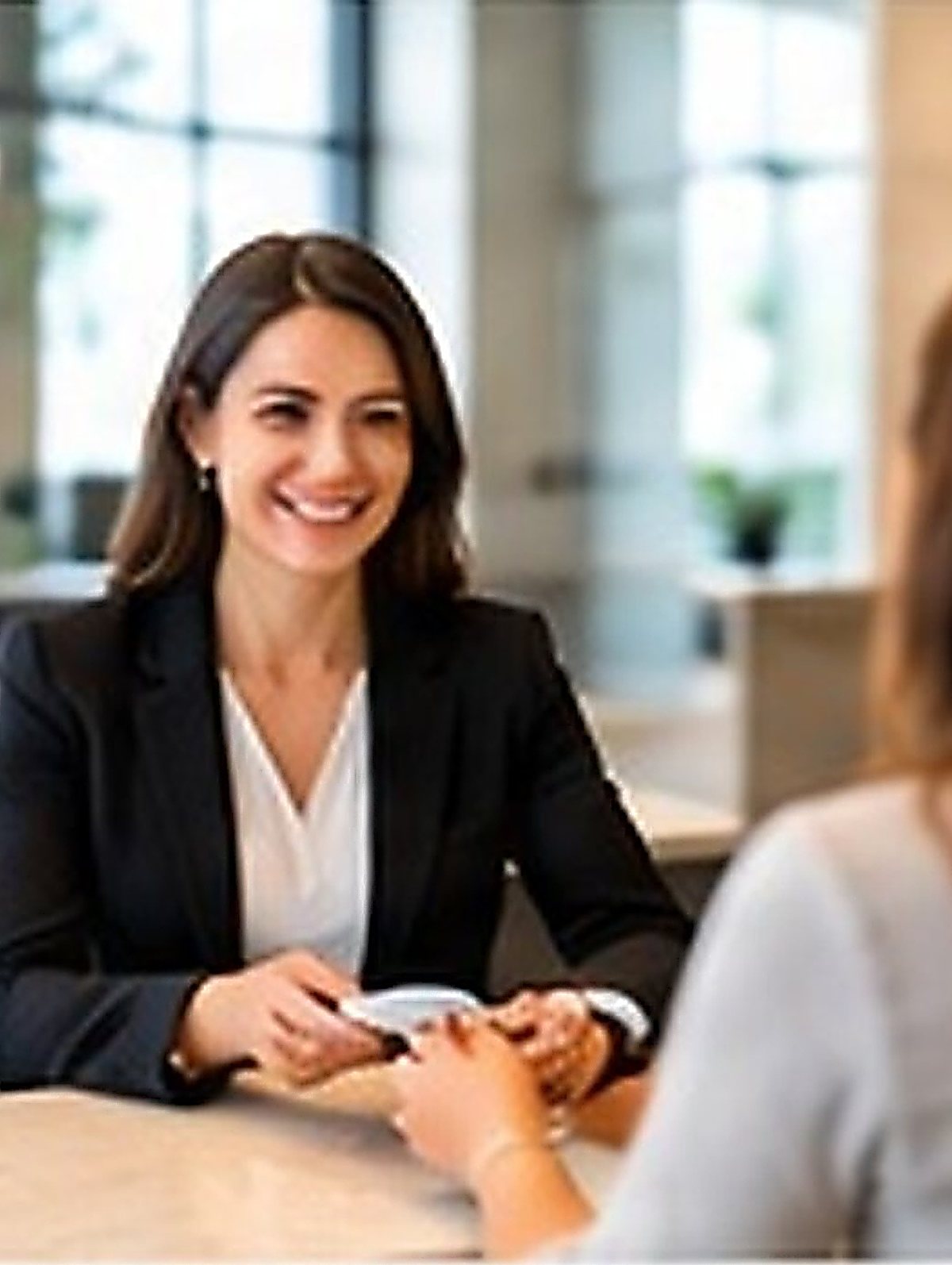 Property manager helping a resident in a bright office